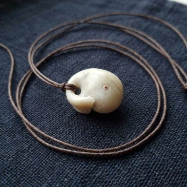 “Moby Dick” white jade whale pendant with faceted garnet eyes. 4cm length.