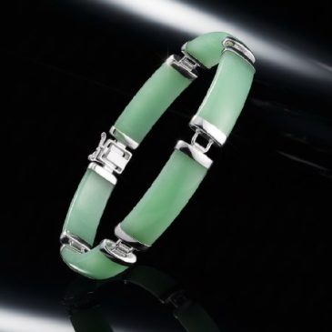 Elegant and timeless, this handcrafted bracelet features polished green jade beads paired with sleek sterling silver accents. A …