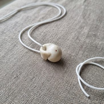 White jade Moby Dick pendant with six faceted gemstone eyes. Elegant, handcrafted, and uniquely detailed….
