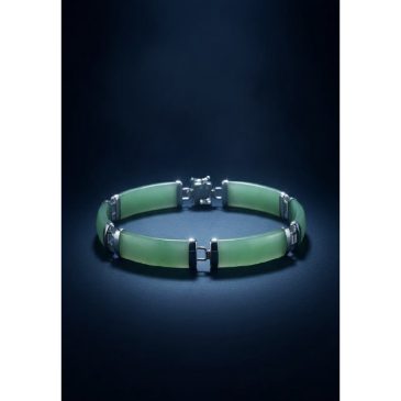 This elegant bracelet features a stunning interplay of deep green jade beads and polished sterling silver accents. A timeless ac…
