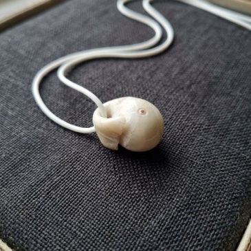 White Nephrite Jade Moby Dick pendant with five faceted stone eyes. Hand-carved elegance for sea lovers….