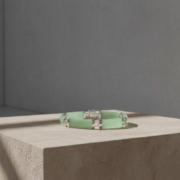 This elegant bracelet seamlessly blends the cooling touch of natural green jade with the timeless luster of polished sterling si…