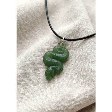 Exquisite craftsmanship meets timeless elegance. This handcrafted nephrite snake pendant features a sleek design accented by pie…