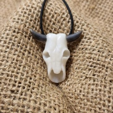 Crafted from white jade and obsidian, this bull skull pendant blends bold design with natural elegance. A unique statement piece…