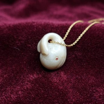 Exquisite handcrafted pendant featuring a serene white jade whale, inspired by Moby Dick. Adorned with two faceted gemstone eyes…