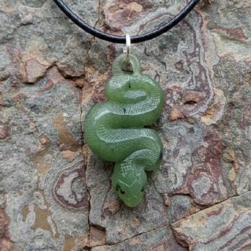 This elegant Nephrite Snake Pendant features deep green stone and vibrant Red Garnet eyes. A timeless piece of artisan jewelry….