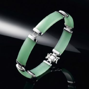 This elegant bracelet features a stunning interplay of natural green jade and polished sterling silver. A timeless accessory tha…