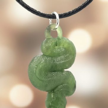 This handcrafted nephrite jade snake pendant features striking red garnet eyes. A timeless symbol of elegance and wisdom, perfec…