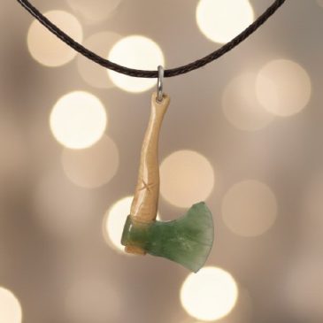 This handcrafted axe pendant features a striking fusion of deep green nephrite jade and ancient petrified wood. The clean lines …