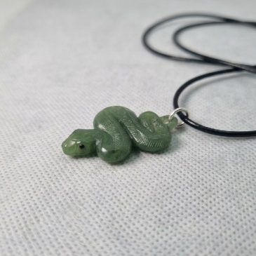 Elegant necklace featuring a hand-carved green jade snake pendant. A symbol of wisdom and rebirth, crafted with timeless natural…