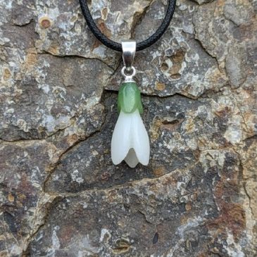 Embrace the timeless elegance of the Snowdrop Pendant. Crafted from exquisite white and green nephrite, this piece captures the …