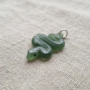 Green jade snake pendant: elegance and wisdom in every detail. Natural stone artistry.
