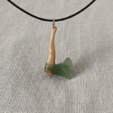 Embodying strength and timeless elegance, this Axe Pendant blends deep green nephrite with the organic texture of petrified wood…